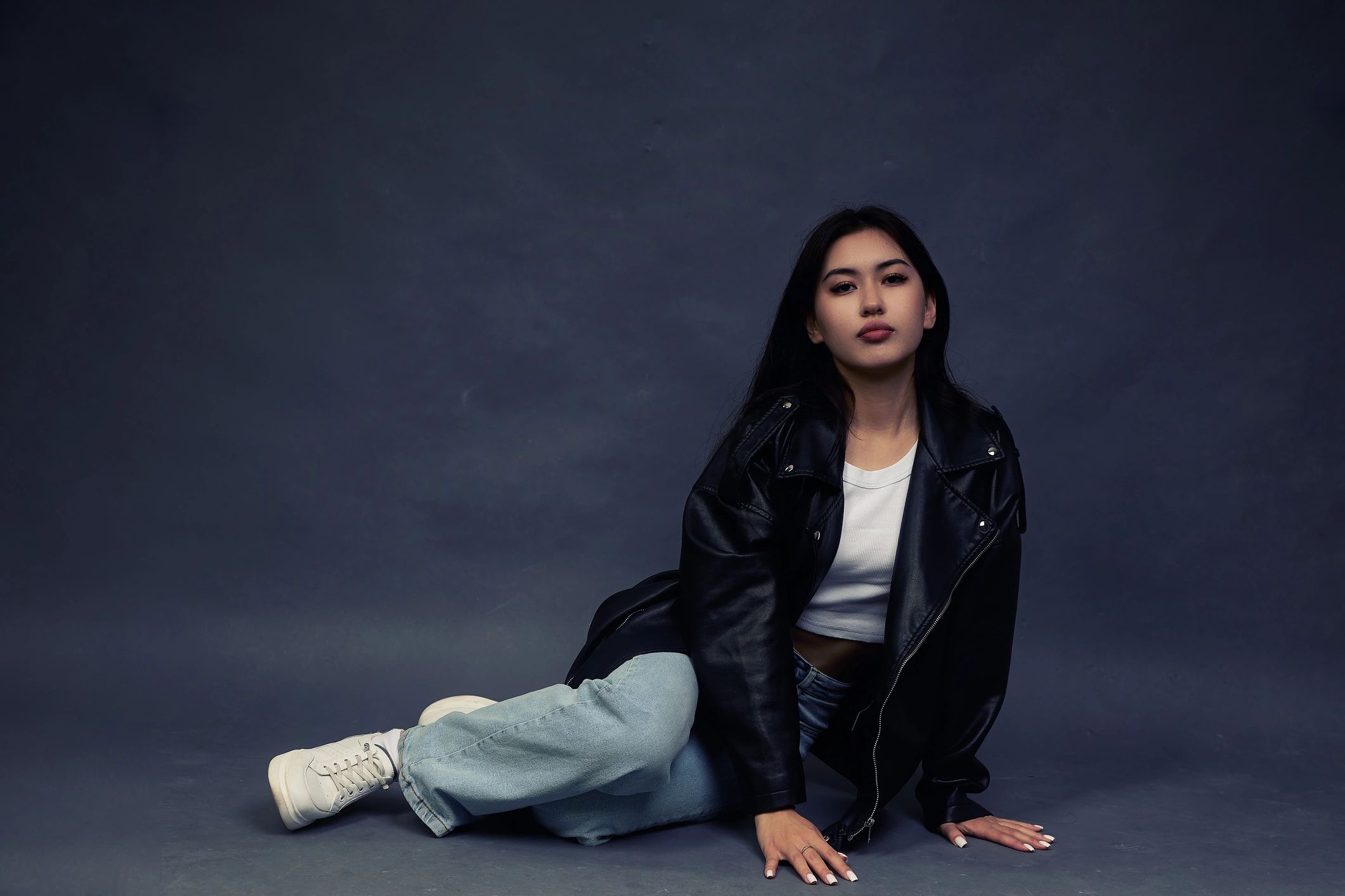 Model in modern outfit posing in studio, representing Timlss style